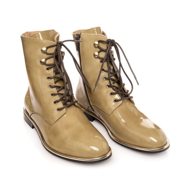 Olive biker boots in patent leather with gold accents, photographed from above